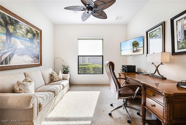 carpeted office featuring ceiling fan