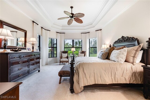 bedroom featuring ceiling fan, crown molding, light carpet, and a raised ceiling