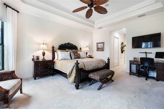 bedroom featuring ceiling fan, light colored carpet, ornamental molding, and a raised ceiling