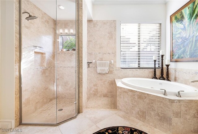 bathroom featuring a stall shower, a garden tub, and tile patterned floors