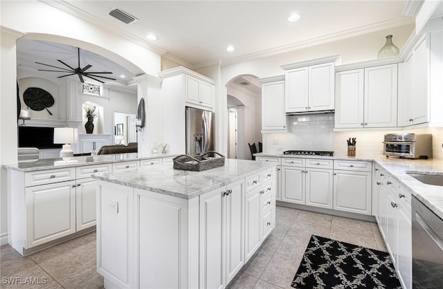 kitchen featuring a center island, visible vents, appliances with stainless steel finishes, white cabinets, and ceiling fan