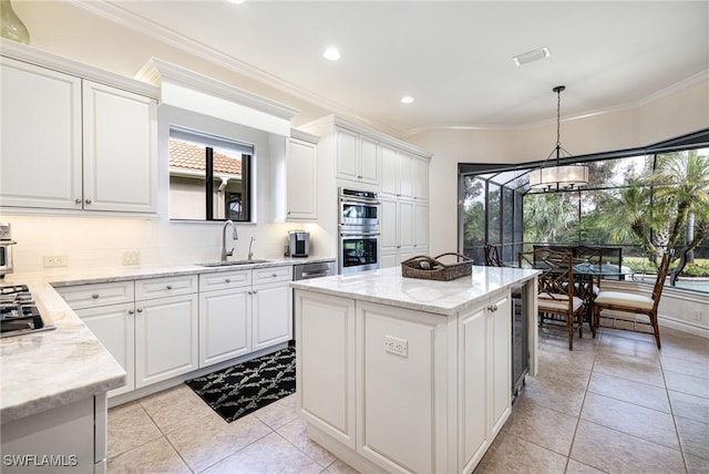 kitchen featuring stainless steel appliances, crown molding, a sink, and tasteful backsplash