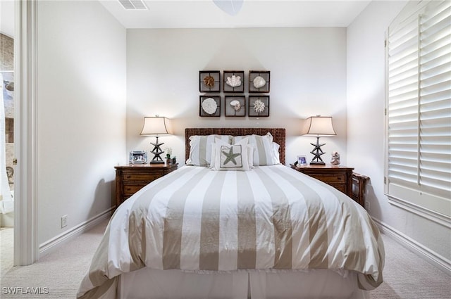 carpeted bedroom featuring visible vents and baseboards