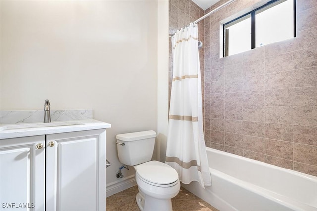 bathroom featuring toilet, shower / tub combo, baseboards, and vanity