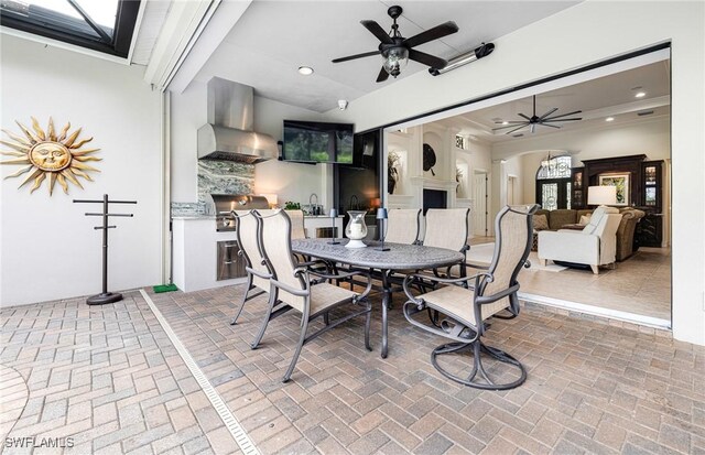 dining area featuring a fireplace and ceiling fan