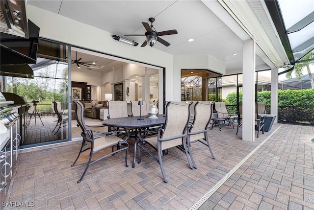 view of patio with outdoor dining space, a lanai, and ceiling fan