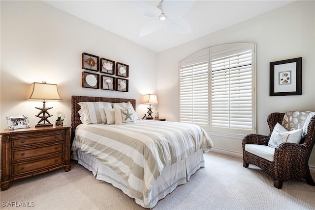 bedroom featuring ceiling fan, baseboards, and light colored carpet