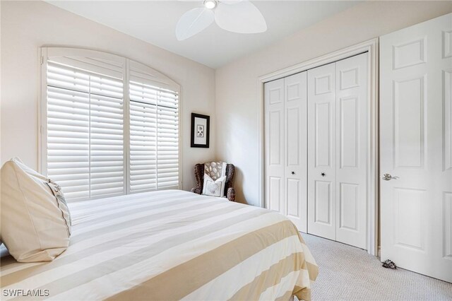 bedroom featuring a closet, ceiling fan, and light colored carpet