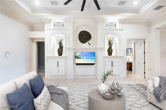 living room with a raised ceiling, ornamental molding, and ceiling fan