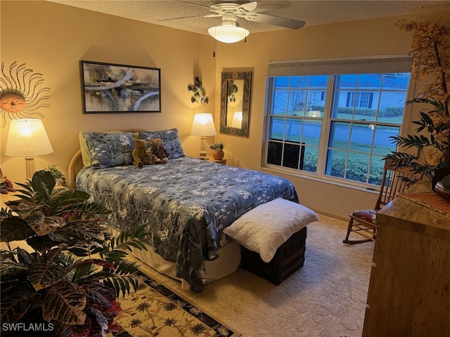 carpeted bedroom with multiple windows, ceiling fan, and a textured ceiling