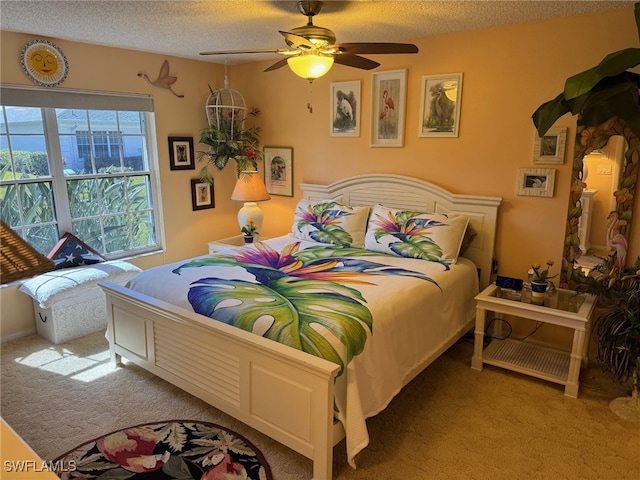 carpeted bedroom featuring a textured ceiling and ceiling fan