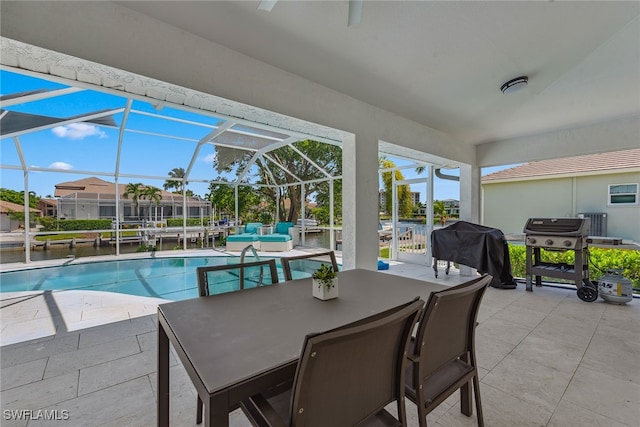 view of swimming pool featuring glass enclosure, area for grilling, and a patio