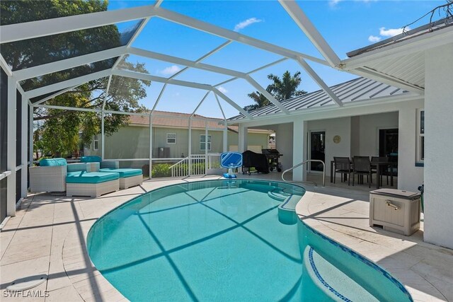 view of swimming pool with a lanai and a patio area