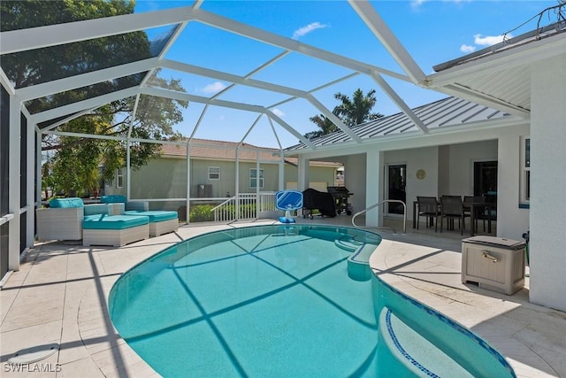 outdoor pool featuring glass enclosure and a patio