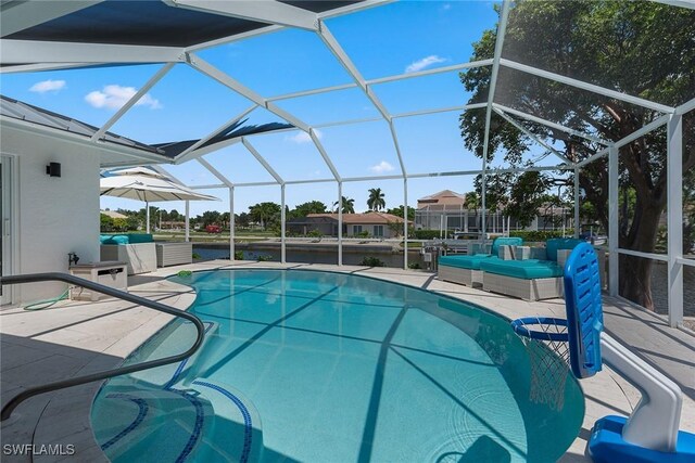 view of pool featuring glass enclosure and a patio