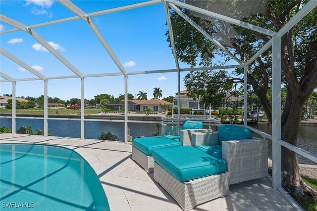 view of pool featuring glass enclosure, a patio, and a water view