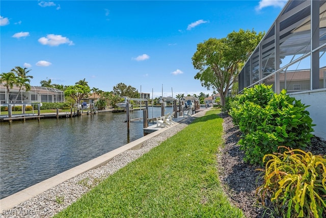 dock area featuring a water view, a yard, and a lanai