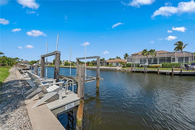 dock area with a water view and boat lift