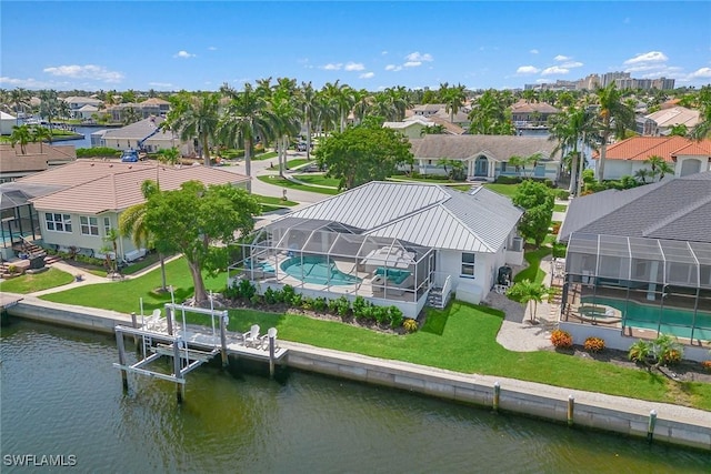 birds eye view of property with a water view and a residential view