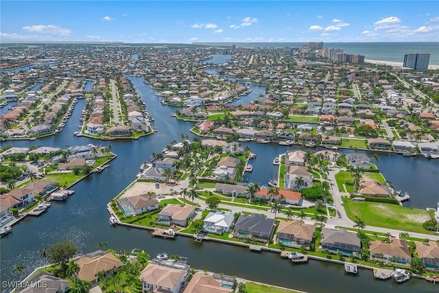 birds eye view of property featuring a water view and a residential view