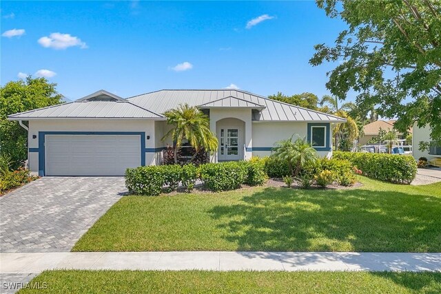 view of front of home with a garage and a front yard