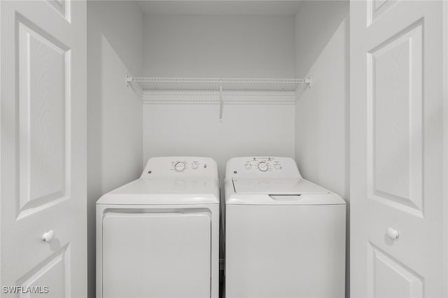 clothes washing area with washer and dryer