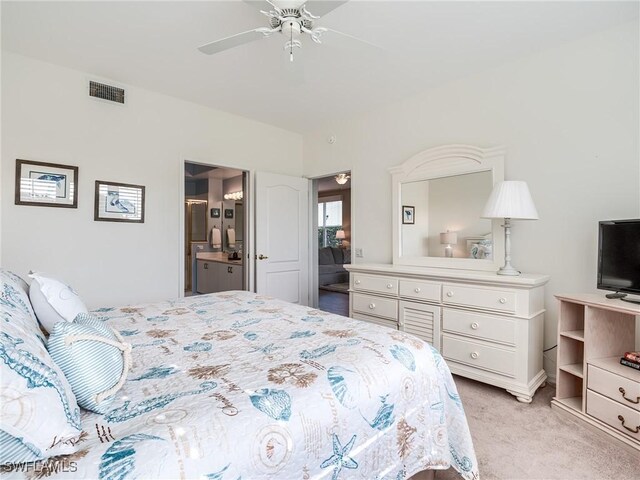 carpeted bedroom featuring connected bathroom and ceiling fan