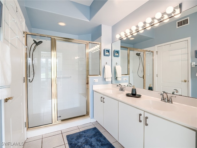 bathroom with vanity, a shower with shower door, and tile patterned flooring