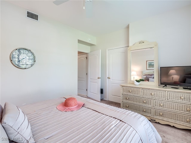 bedroom featuring ceiling fan and light carpet