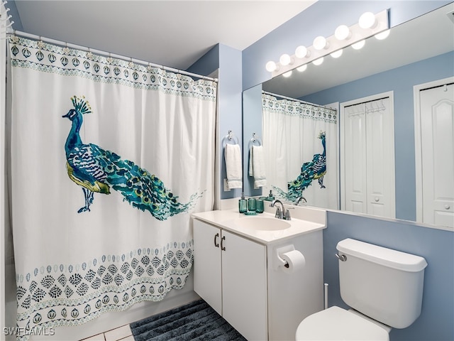 bathroom featuring vanity, toilet, a shower with shower curtain, and tile patterned floors