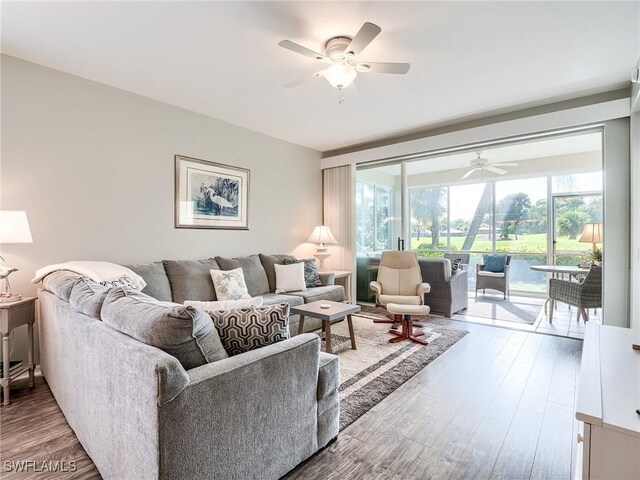 living room featuring ceiling fan and hardwood / wood-style flooring