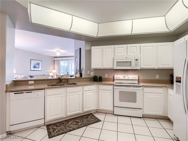 kitchen featuring sink, white appliances, and white cabinets