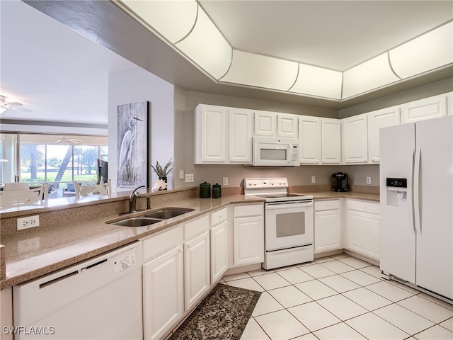 kitchen featuring light tile patterned floors, white appliances, sink, and white cabinets