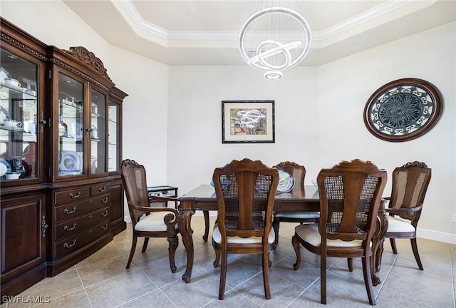 dining area featuring a raised ceiling, light tile patterned flooring, crown molding, and a notable chandelier