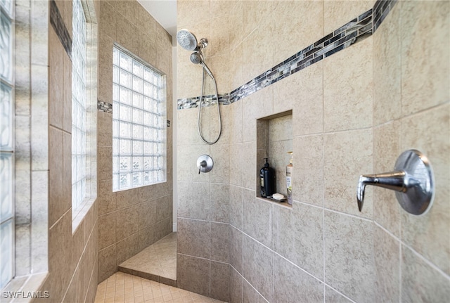 bathroom with a tile shower