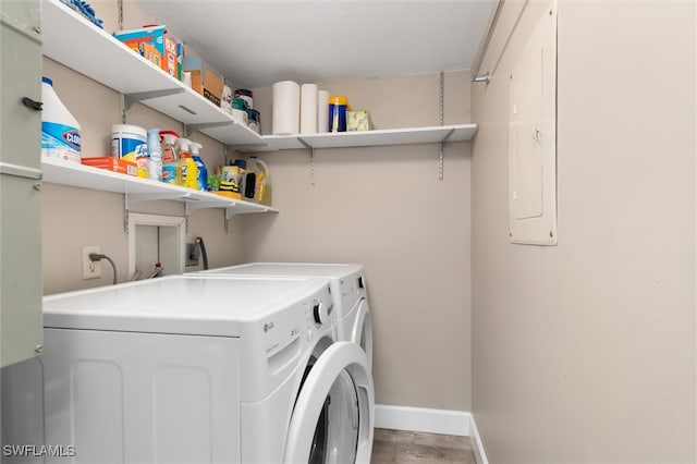 laundry room featuring electric panel and separate washer and dryer