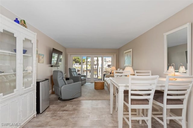 living room with light hardwood / wood-style floors and french doors