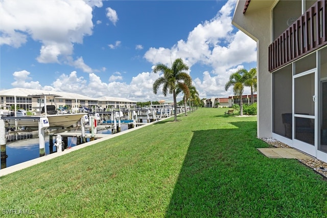 view of dock with a water view and a yard