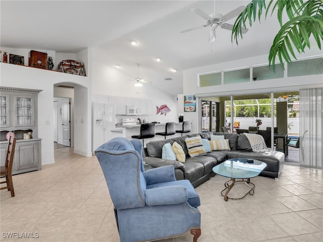 tiled living room with high vaulted ceiling and ceiling fan