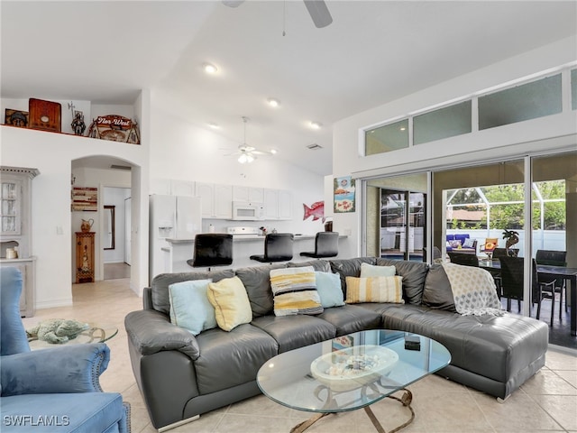 living room with high vaulted ceiling, light tile patterned flooring, and ceiling fan