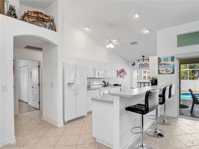 kitchen with white appliances, a healthy amount of sunlight, kitchen peninsula, and ceiling fan