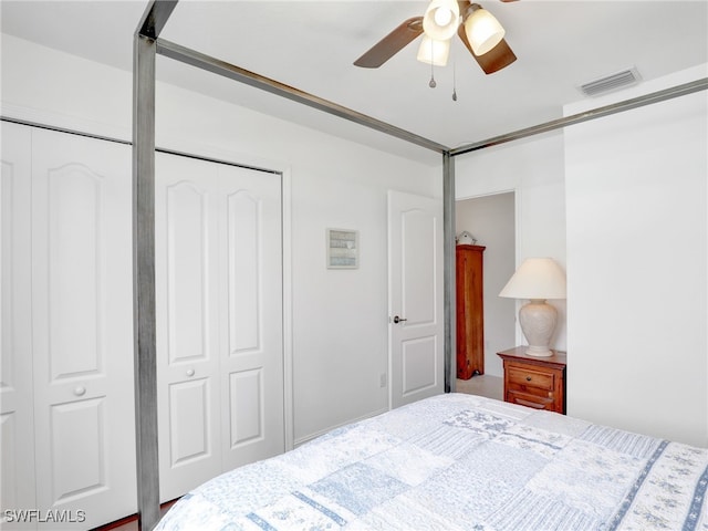 bedroom with ceiling fan and multiple closets