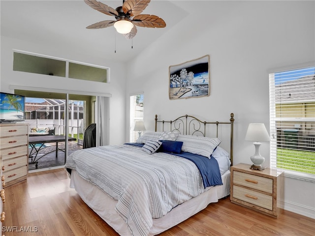 bedroom with light wood-type flooring, multiple windows, access to exterior, and ceiling fan