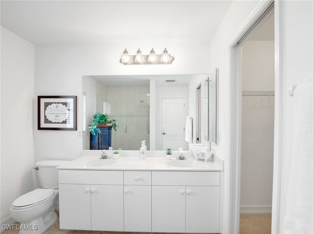 bathroom featuring vanity, toilet, tile patterned floors, and walk in shower