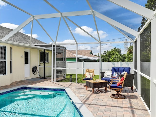 view of swimming pool featuring an outdoor living space, glass enclosure, and a patio area