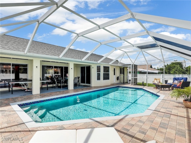 view of swimming pool with a lanai and a patio area