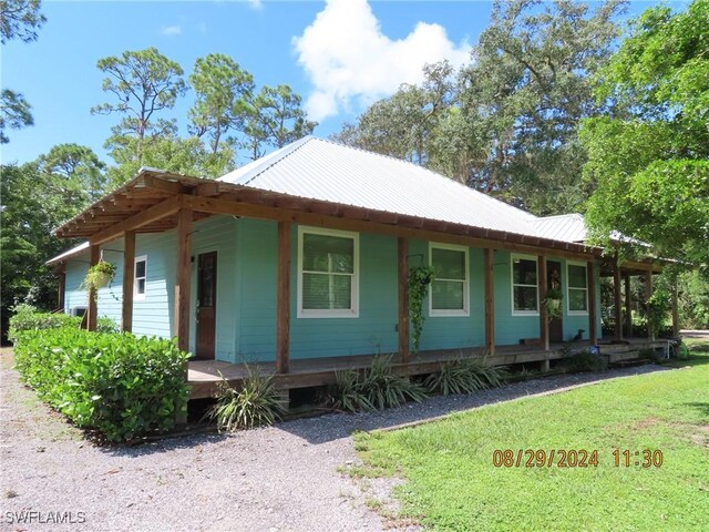 view of home's exterior featuring a porch and a lawn