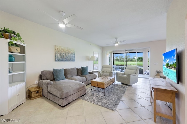 living area featuring light tile patterned floors and a ceiling fan