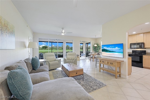 living room featuring ceiling fan and light tile patterned floors