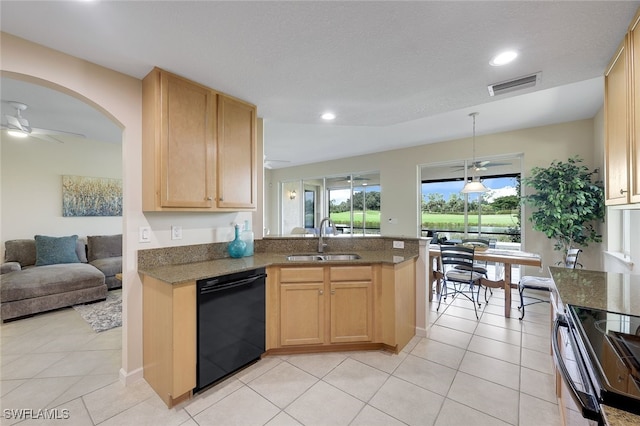 kitchen featuring light brown cabinets, black appliances, a sink, and visible vents